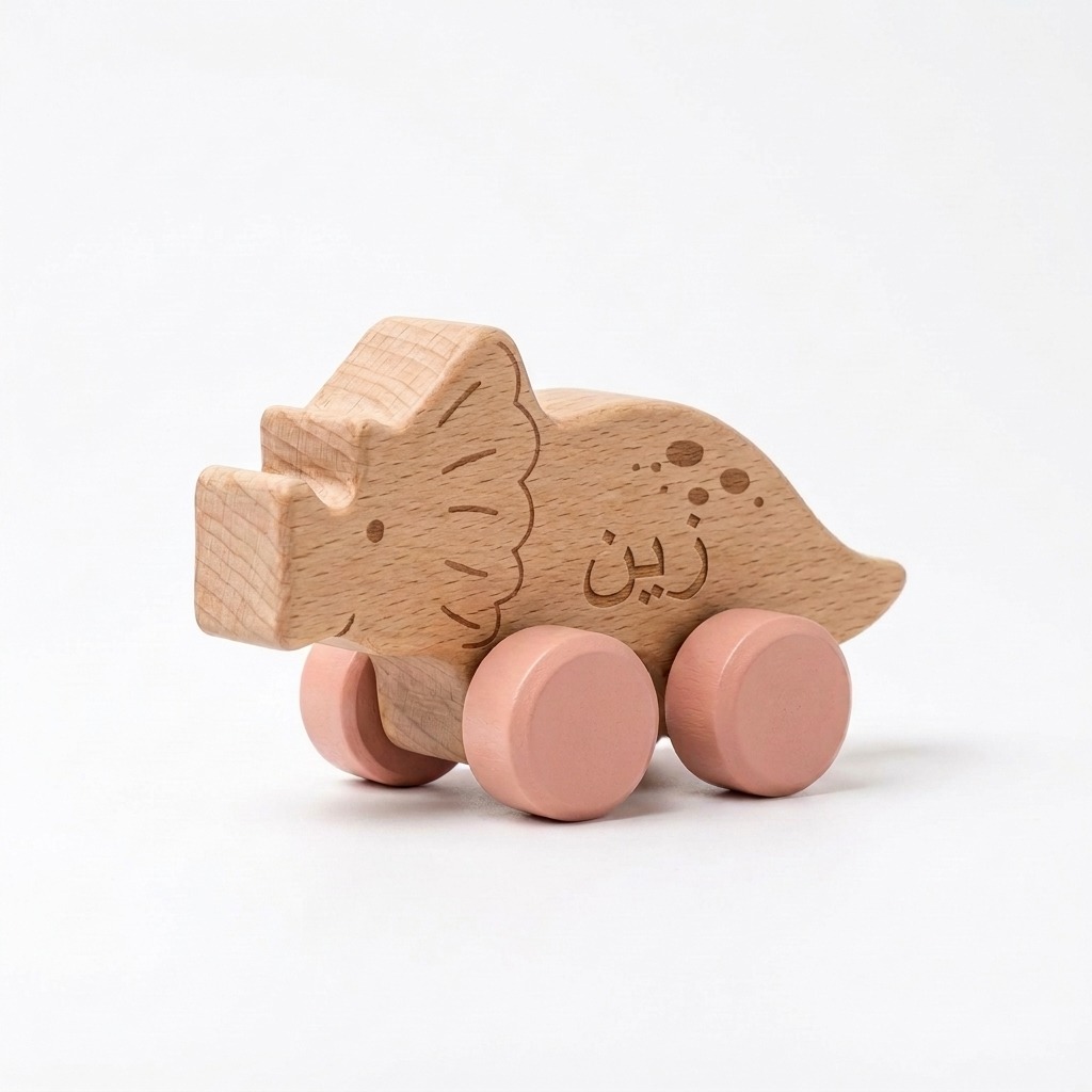 Dinosaur Wooden Push Toy 4 Personalized gugu wooden triceratops push toy with pink wheels and an engraved Arabic name.